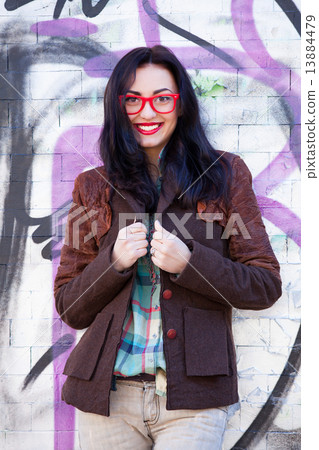 Teen girl near graffiti wall. Teen girl near graffiti wall. 13884479