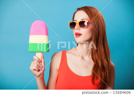 Redhead girl with toy ice cream on blue background. Redhead girl with toy ice cream on blue background. 13884606