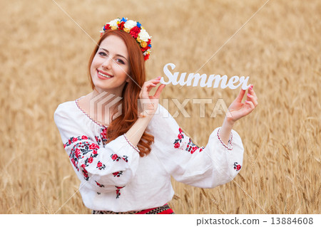 Redhead girl in national ukrainian clothes with wooden word Summ Redhead girl in national ukrainian clothes with wooden word Summ 13884608