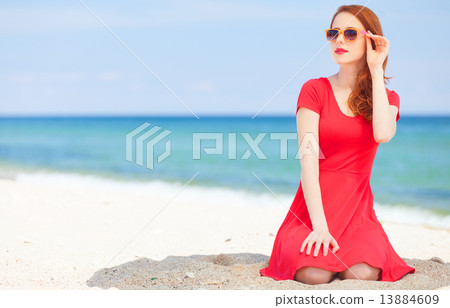 Redhead girl in the sunglasses on the beach Redhead girl in the sunglasses on the beach 13884609