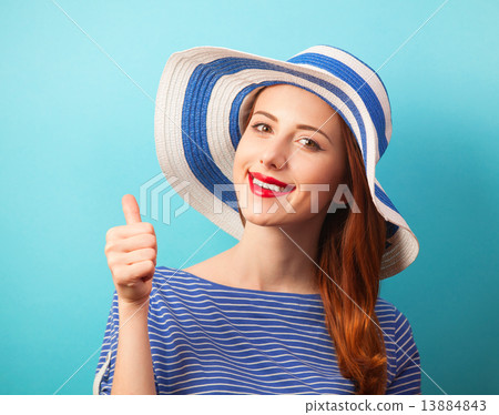 Redhead girl in hat on blue background. Redhead girl in hat on blue background. 13884843