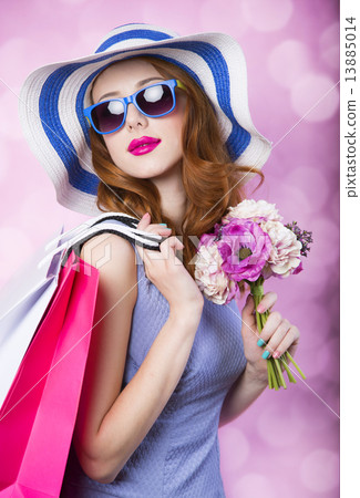 Redhead girl with shopping boxes and flowers on pink background. Redhead girl with shopping boxes and flowers on pink background. 13885014