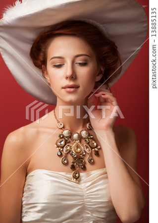Portrait of redhead edvardian women on red background. 13885135