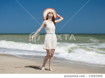 Redhead girl on the beack in spring time Redhead girl on the beack in spring time 13885909