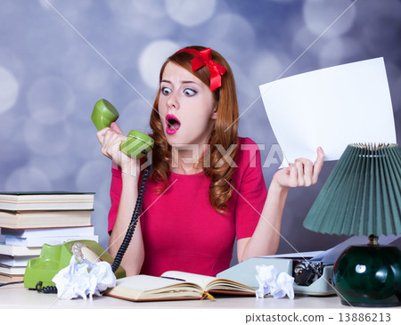 Woman at typewriter on telephone 13886213