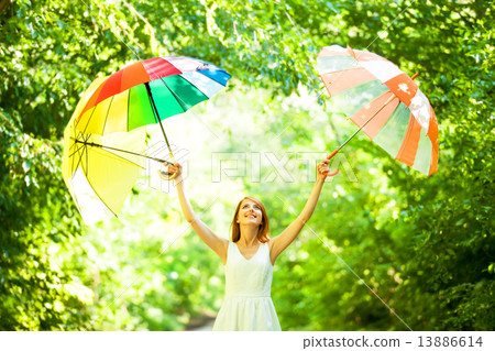 Redhead girl with three umbrellas at outdoor Redhead girl with three umbrellas at outdoor 13886614