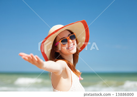 Redhead girl on the beach in spring time. 13886800