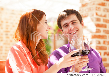 Couple drinking wine in the cafe 13887600