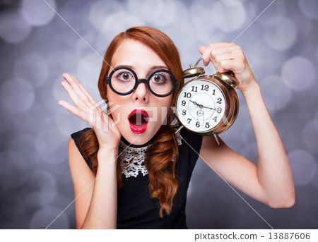 Surprised redhead girl with clock. Surprised redhead girl with clock. 13887606