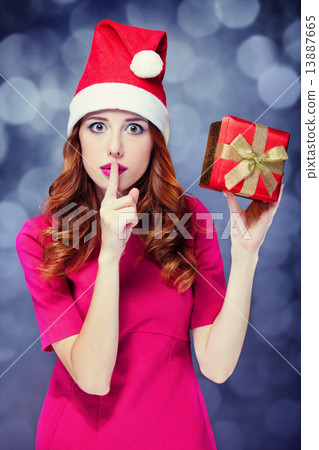 Redhead girl in christmas hat with gift. 13887665