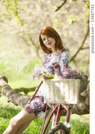 Girl on a bike in the countryside Girl on a bike in the countryside 13887742