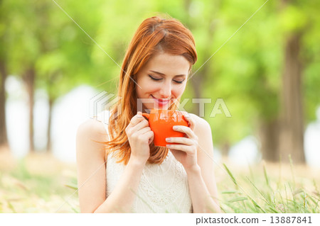 Redhead girl with orange cup at outdoor Redhead girl with orange cup at outdoor 13887841