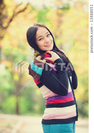 Brunette girl at autumn alley in the park Brunette girl at autumn alley in the park 13888051