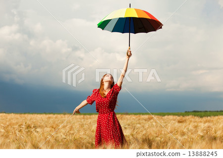Redhead girl with umbrella at field 13888245