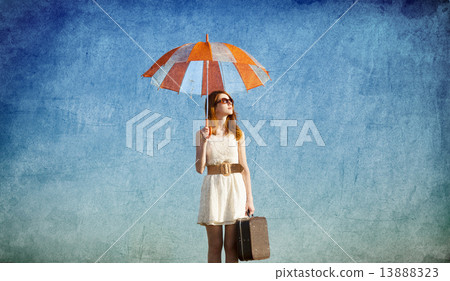 Redhead girl with umbrella at blue sky background 13888323