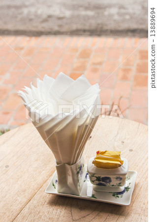 Tissue paper on wood table in coffee shop 13889694