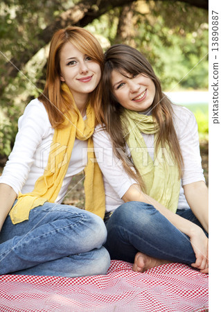 Portrait of redhead and brunette girls at outdoor. 13890887