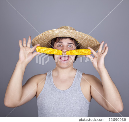 Funny farmer in cap with two corns. 13890986