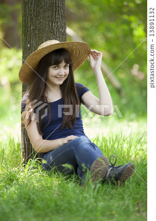 Young fashion girl in white hat at green grass. 13891132