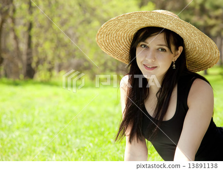 Beautiful brunette girl in hat at the park. Beautiful brunette girl in hat at the park. 13891138