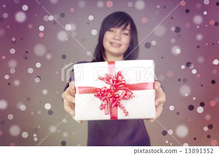 Beautiful brunette girl with present box in the hands Beautiful brunette girl with present box in the hands 13891352