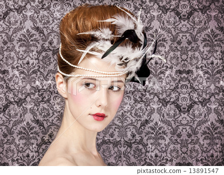 Surprised redhead girl with Rococo hair style at vintage backgro 13891547