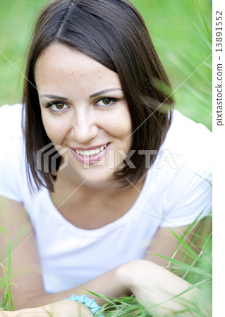 Beautiful teen girl in the park at green grass. 13891552