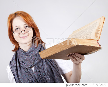 Young smiling fashion girl in glasses with old book Young smiling fashion girl in glasses with old book 13891713