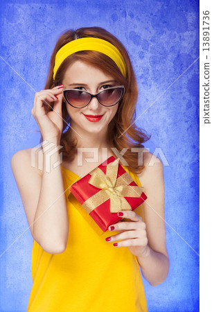 American redhead girl in sunglasses with gift. 13891736