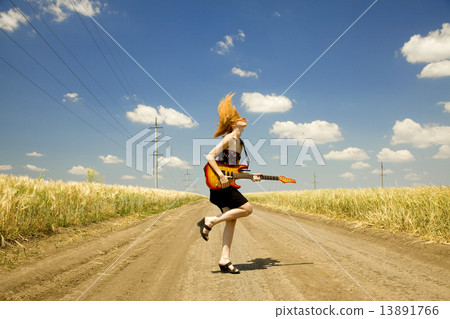 Rock girl with guitar at countryside. 13891766
