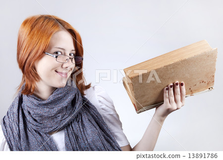 Young smiling fashion girl in glasses with age book. Young smiling fashion girl in glasses with age book. 13891786
