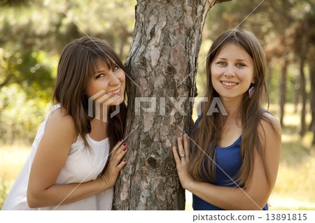 Two happy sisters at the park. Two happy sisters at the park. 13891815