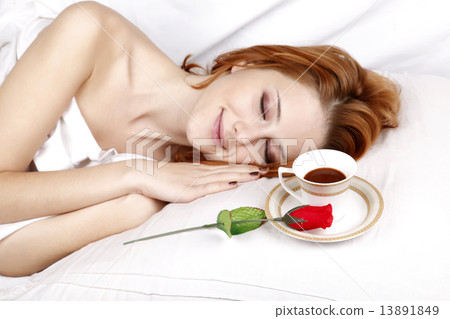 Red rose and cup of coffee near sleeping woman 13891849