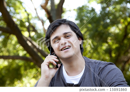 Beautiful brunette men calling by mobile at outdoor. 13891860