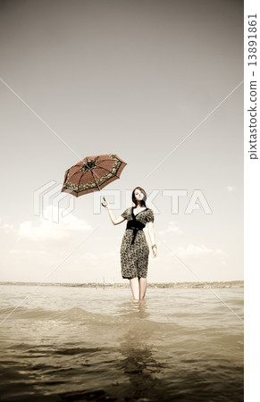 Girl with umbrella on bike. Photo in old image style. Girl with umbrella on bike. Photo in old image style. 13891861