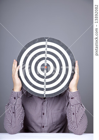 Boy with dartboard in place of head. Boy with dartboard in place of head. 13892082