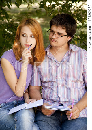 Two students at outdoor doing homework. Two students at outdoor doing homework. 13892083