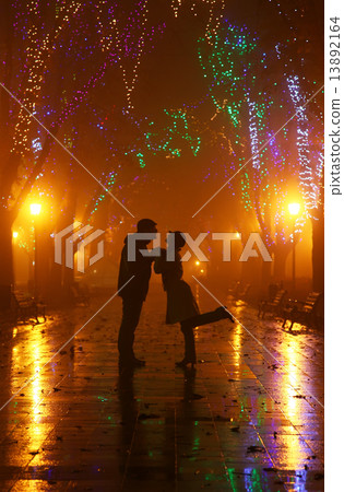 Couple walking at alley in night lights. Photo in vintage style. 13892164