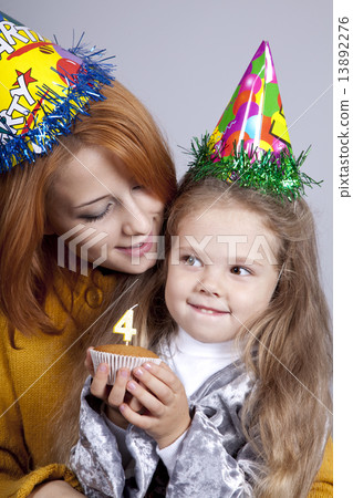 Two sisters four and eighteen years old at birthday. Two sisters four and eighteen years old at birthday. 13892276