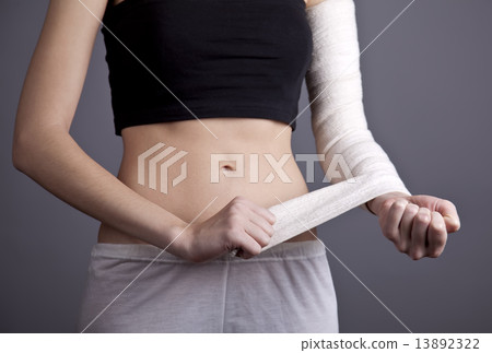 Strong girl's body with with elastic bandage on hand. 13892322