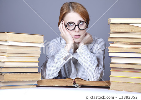The young teacher in glasses with books. 13892352