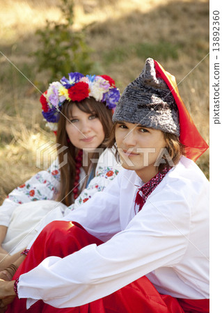 Slav girl with wreath and young cossack at nature 13892360