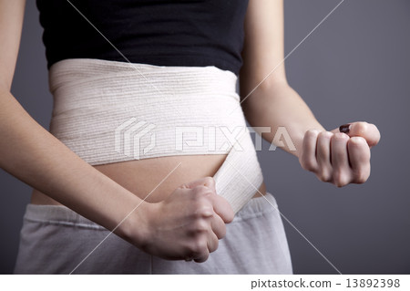 Strong girl's body with with elastic bandage on abs Strong girl's body with with elastic bandage on abs 13892398