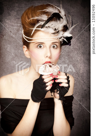 Redhead girl with Rococo hair style and cake in studio at vintag 13892496
