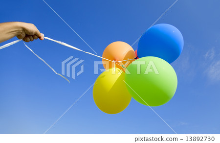 Female holding multicolored balloons 13892730