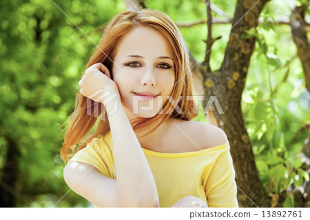 Redhead girl at summer park. Redhead girl at summer park. 13892761