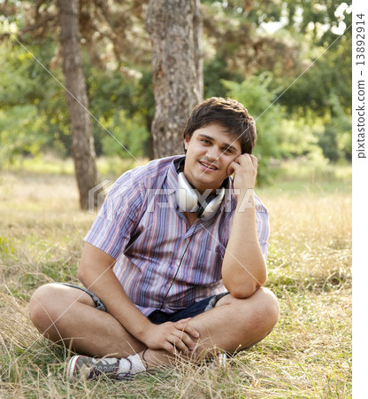 Smiling handsome man with headphones at outdoors Smiling handsome man with headphones at outdoors 13892914