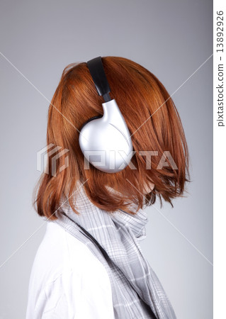 Unusual red-haired girl with headphones 13892926
