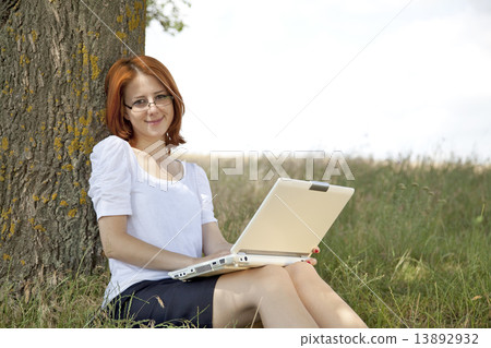 Young Businesswomen in white with glasses and laptop sitting nea 13892932