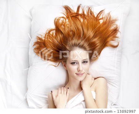 Fashion red-haired girl in the bedroom. 13892997